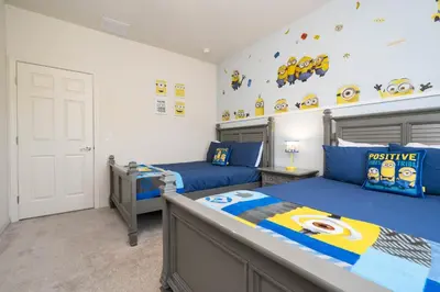 a bedroom with two twin beds and a wall with superman decals at Villa Coelho - West Lucaya Resort in Kissimmee