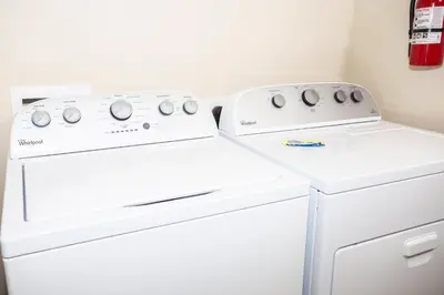 two washing machines sitting next to each other in a laundry room at Villa Compass- Compass Bay in Kissimmee