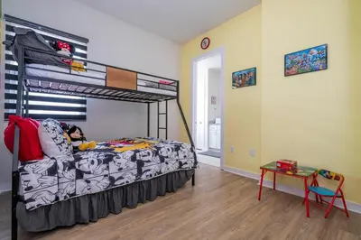 a bedroom with a bed and a bunk bed at Magic Villa Orlando in Orlando