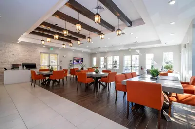 a dining room with tables and chairs in a restaurant at Magic Villa Orlando in Orlando