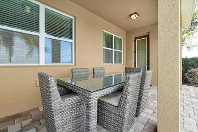 a patio with a glass table and chairs at 261 LASSO DRIVE 6BED in Orlando