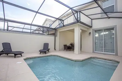 a house with a swimming pool with a glass ceiling at Villa Ariel- Storey Lake in Kissimmee