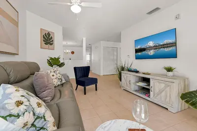 a living room with a couch and a chair at 2728 CLUB CORTILE CIRCLE UNIT A 3BED in Kissimmee