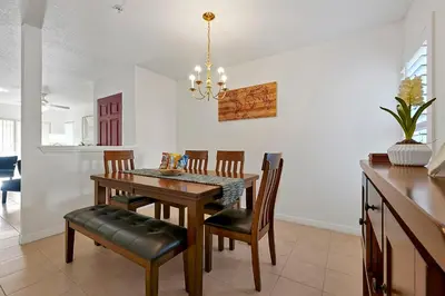 a dining room with a table and chairs at 2728 CLUB CORTILE CIRCLE UNIT A 3BED in Kissimmee