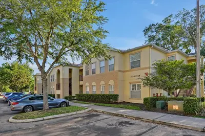 a building with a car parked in front of it at 2728 CLUB CORTILE CIRCLE UNIT A 3BED in Kissimmee