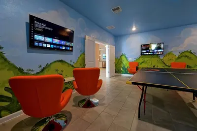 a gaming room with a ping pong table and chairs at 2968 PENELOPE LOOP 10 BED in Kissimmee