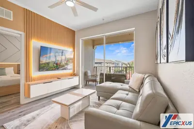 a living room with a couch and a table at The Epic Cork Vista Cay Orlando in Orlando