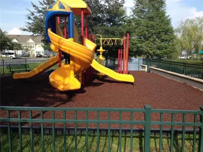 a playground with a yellow slide in a park at 4005 SAN SABASTIAN DRIVE 3BED in Kissimmee