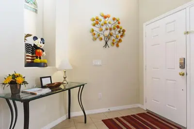 a room with a table and a white door at Veranda Palms Villa: Pool, Spa & Game Room in Kissimmee