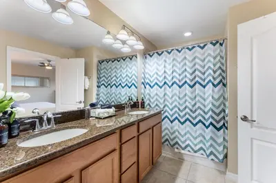 a bathroom with a sink and a shower at 4BR Retreat with Resort Access and Pool in Kissimmee
