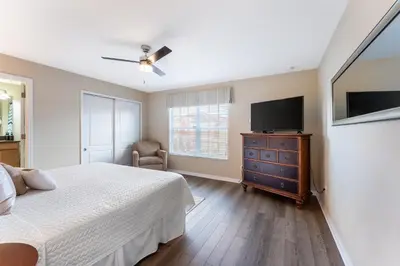 a bedroom with a bed and a flat screen tv at 4BR Retreat with Resort Access and Pool in Kissimmee