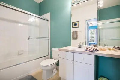 a bathroom with a toilet and a shower and a sink at Windsor Palms Condo | Pool, Spa & Near Disney in Kissimmee
