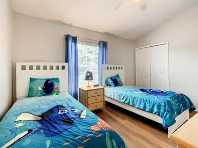 a bedroom with two beds and a window at Windsor Palms Townhome w/Private Pool Near Disney in Kissimmee