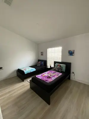 a bedroom with two beds and a couch at Townhome in Orlando
