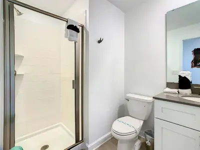 a white bathroom with a toilet and a shower at Lovely Themed Room with Private Pool in Kissimmee