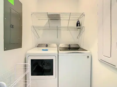 a kitchen with a stove and a washer at Lovely Themed Room with Private Pool in Kissimmee