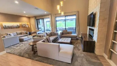 a living room with white couches and a television at 3053 Magic Village - Jacuzzi excepcional, a 8 minutos da Disney in Orlando