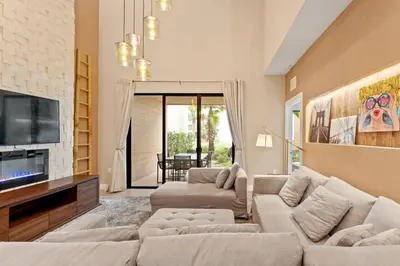 a living room with two couches and a tv at Magic Village: charme e conforto a 8 min da Disney in Orlando