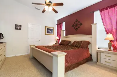 a bedroom with a bed and a ceiling fan at Windsor Palms Villa: Pool & Close to Disney in Kissimmee