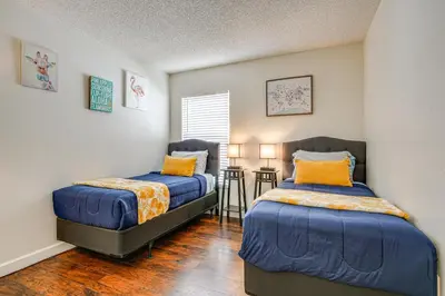 a bedroom with two beds and a table at 9 Mi to Disney Home with Pool Table and Water Views! in Kissimmee