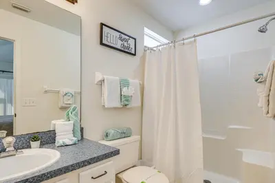 a bathroom with a sink and a toilet and a shower at 9 Mi to Disney Home with Pool Table and Water Views! in Kissimmee