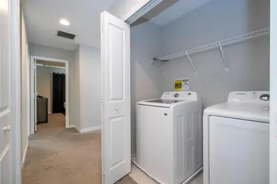 a laundry room with a washer and dryer at Beautiful 4BD home Themed Pool and Grill 4403 in Kissimmee