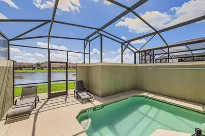 a swimming pool in a building with a glass roof at Luxury 5BR Townhome w Pool & Resort Access in Kissimmee