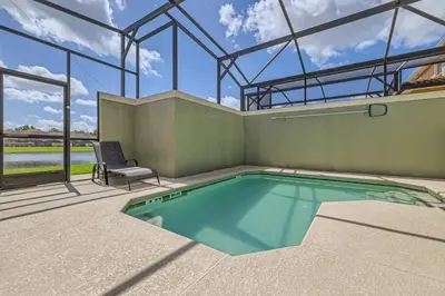 a swimming pool in a house with a glass ceiling at Luxury 5BR Townhome w Pool & Resort Access in Kissimmee