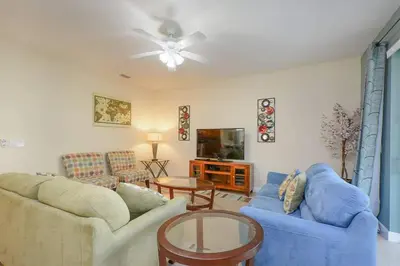 a living room with two couches and a tv at Spacious 6BR Villa Sleeps 14 in Kissimmee