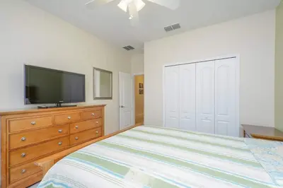 a bedroom with a bed and a flat screen tv at Spacious 6BR Villa Sleeps 14 in Kissimmee