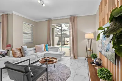 a living room with a couch and a table at Relaxing Getaway Near Disney with Pool & Themed Rooms in Kissimmee