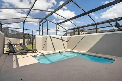a swimming pool in a building with a glass roof at Relaxing Getaway Near Disney with Pool & Themed Rooms in Kissimmee