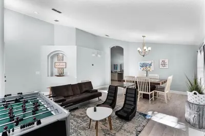 a living room with a pool table and a living room with a bill at Ultimate family resort home with incredible sunset views, 4 miles from Disney! in Kissimmee
