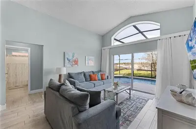 a living room with two couches and a large window at Ultimate family resort home with incredible sunset views, 4 miles from Disney! in Kissimmee