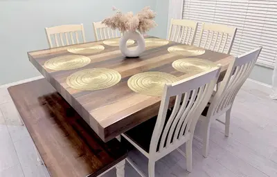 a dining room table with chairs and a vase on it at Ultimate family resort home with incredible sunset views, 4 miles from Disney! in Kissimmee