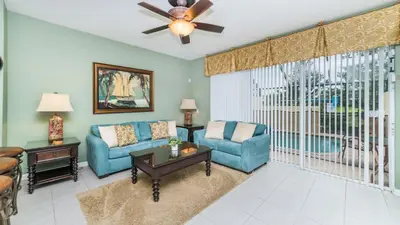 a living room with a blue couch and chairs at Windsor Hills Resort Vacation in Orlando