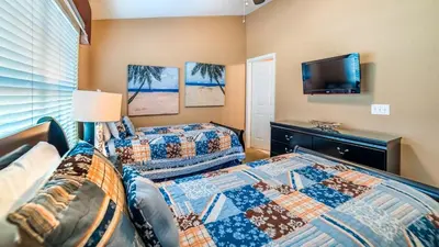 two beds in a room with a tv and a couch at Windsor Hills Resort Vacation in Orlando