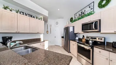 a kitchen with white cabinets and granite counter tops at Windsor Palms Resort Vacation Home 5BR in Kissimmee