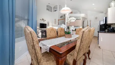 a dining room with a wooden table and chairs at Windsor Palms Resort Vacation Home 5BR in Kissimmee