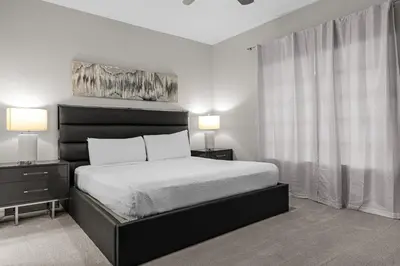 a bedroom with a bed with two night stands and two lamps at 3 Bedroom Family Friendly Condo at WorldQuest near Disney 2714 in Orlando