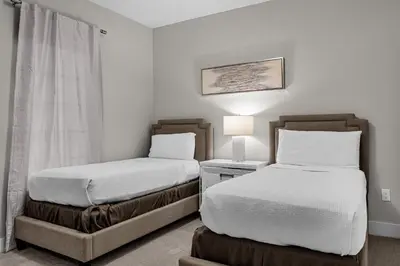 a bedroom with two beds and a lamp in it at 3 Bedroom Family Friendly Condo at WorldQuest near Disney 2729 in Orlando
