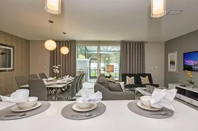 a living room with a table with hats on it at Beautiful 4BD home Themed Pool and Grill 4417 in Kissimmee