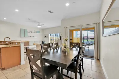 a kitchen and dining room with a table and chairs at CAP8859 in Kissimmee