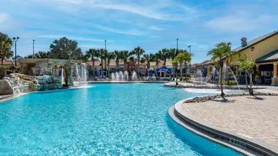 a swimming pool with a waterfall in a resort at CAL8959 in Kissimmee