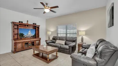 a living room with a couch and a tv at CAT8967 in Kissimmee