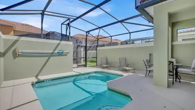 a swimming pool in a house with a glass roof at CAT8967 in Kissimmee