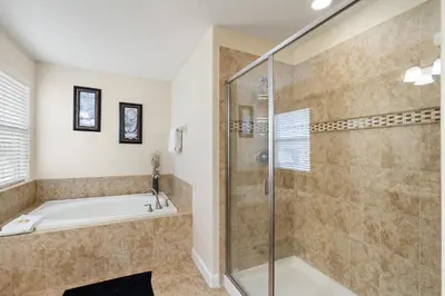 a bathroom with a tub and a shower stall at CUP8949 in Kissimmee