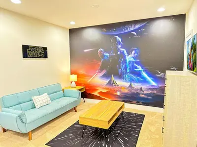 a living room with a blue couch and a wall mural at TR1433SL - Island House Orlando in Orlando