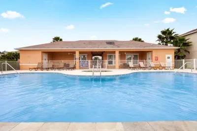 a large swimming pool in front of a house at TR1433SL - Island House Orlando in Orlando
