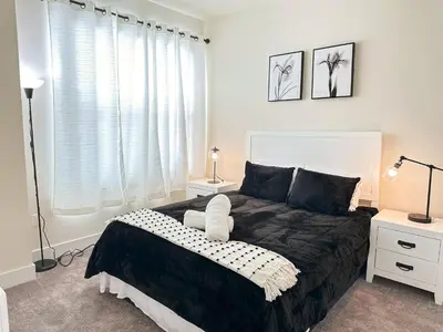 a bedroom with a black and white bed and a window at TR1386PNW - 9 guests - pool home close to Disney in Clermont